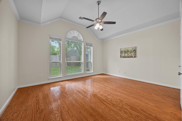 unfurnished room featuring crown molding, baseboards, ceiling fan, wood finished floors, and lofted ceiling