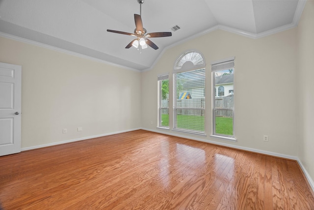 unfurnished room with vaulted ceiling, crown molding, wood finished floors, baseboards, and ceiling fan
