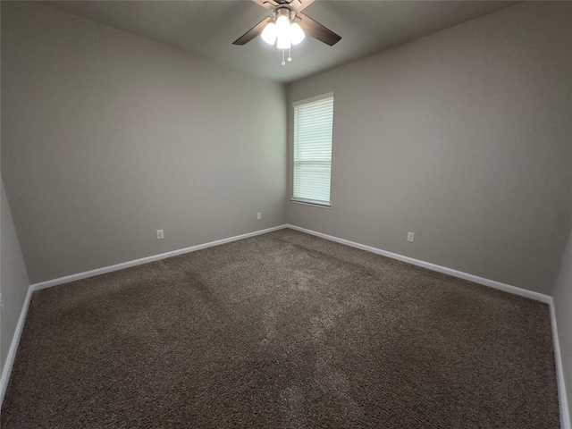 carpeted spare room featuring baseboards and ceiling fan