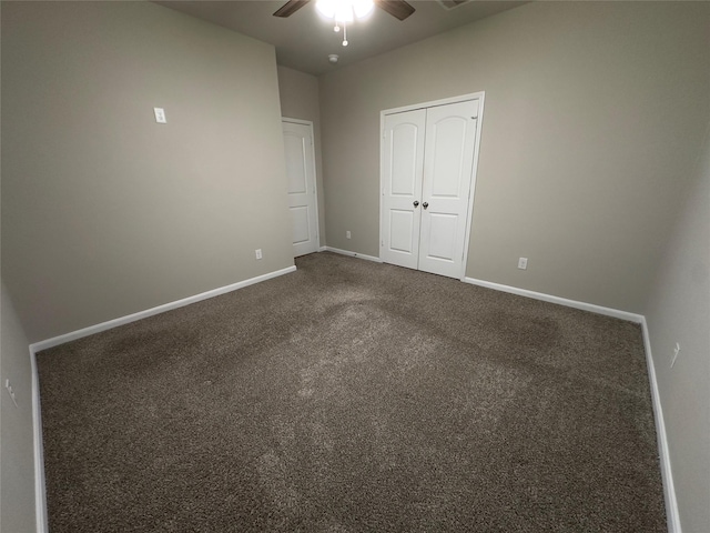 unfurnished bedroom featuring visible vents, baseboards, a closet, a ceiling fan, and dark colored carpet