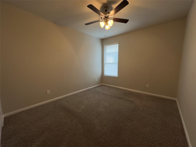 unfurnished room featuring a ceiling fan, baseboards, and dark colored carpet