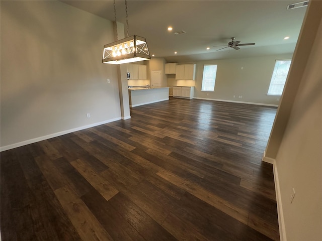 unfurnished living room with visible vents, a ceiling fan, dark wood-style floors, recessed lighting, and baseboards