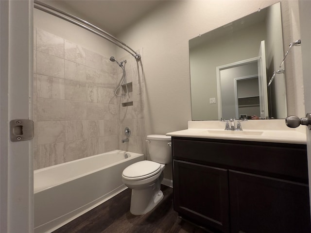 bathroom featuring shower / bathtub combination, toilet, wood finished floors, and vanity