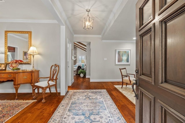 foyer with baseboards, an inviting chandelier, dark wood finished floors, and crown molding