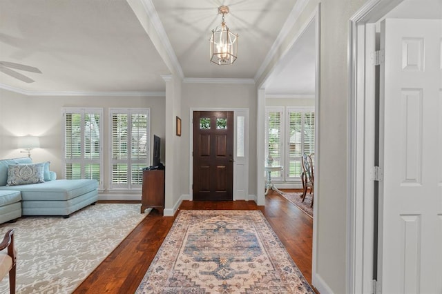 entrance foyer featuring dark wood-style floors, baseboards, and ornamental molding