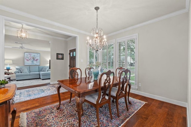 dining area featuring dark wood finished floors, ceiling fan with notable chandelier, baseboards, and ornamental molding