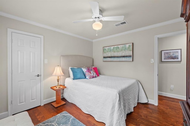 bedroom featuring visible vents, ornamental molding, baseboards, and wood finished floors