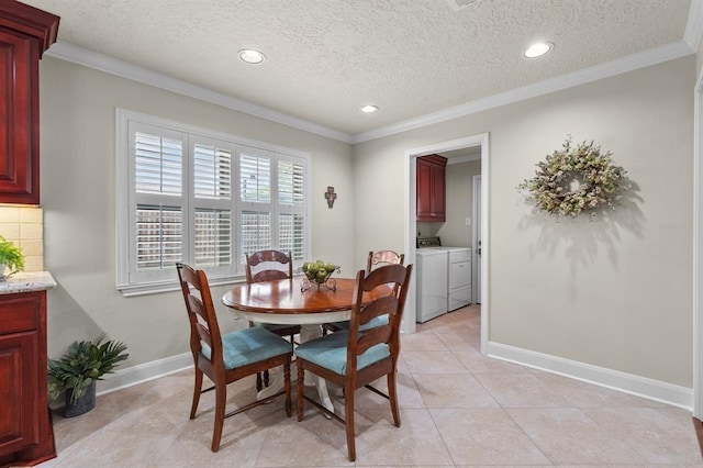 dining area with crown molding, baseboards, washer and clothes dryer, light tile patterned flooring, and a textured ceiling