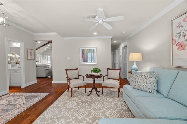 living area featuring baseboards, crown molding, a ceiling fan, and wood finished floors