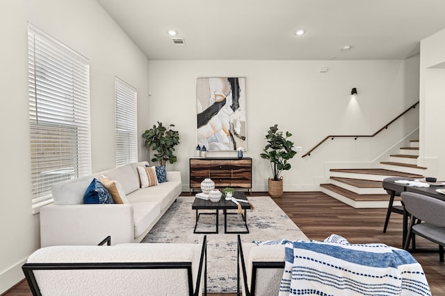 living area featuring stairway, wood finished floors, visible vents, baseboards, and recessed lighting