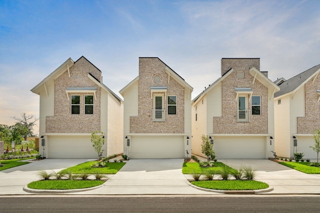 traditional-style home featuring concrete driveway, brick siding, and a garage