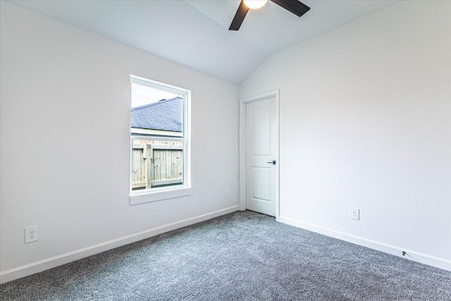 carpeted empty room with lofted ceiling, baseboards, and ceiling fan