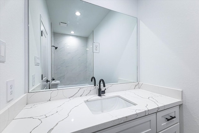 full bath with recessed lighting, toilet, a stall shower, and vanity