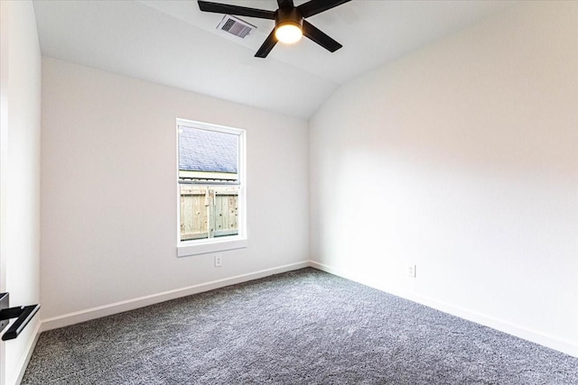 spare room with carpet, baseboards, visible vents, ceiling fan, and vaulted ceiling