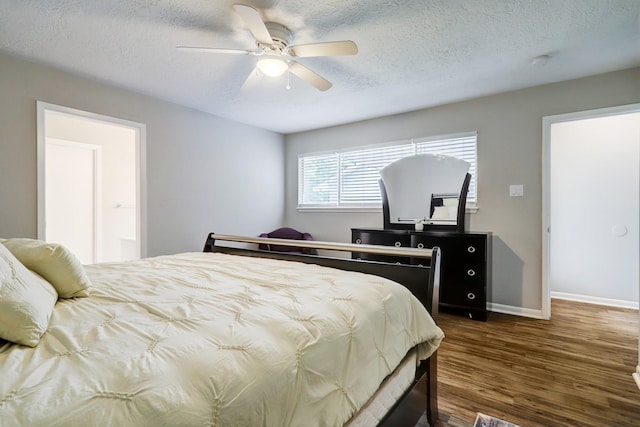 bedroom featuring ceiling fan, baseboards, a textured ceiling, and dark wood-style floors