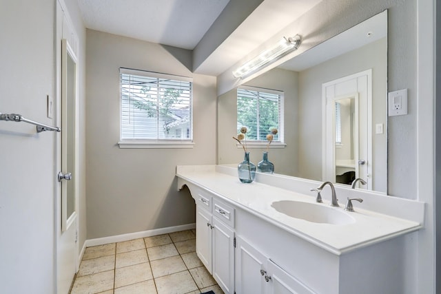 bathroom featuring tile patterned floors, baseboards, and vanity