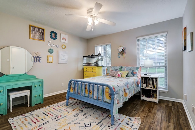 bedroom with a ceiling fan, wood finished floors, and baseboards