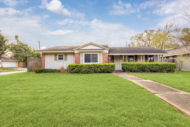 ranch-style house featuring brick siding, board and batten siding, a front lawn, and fence