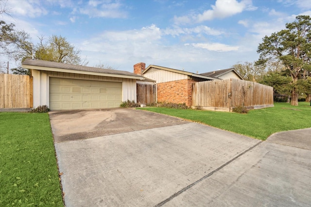 view of front of house with concrete driveway, a front lawn, and fence