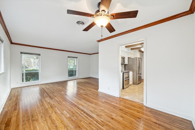 unfurnished living room featuring baseboards, visible vents, light wood finished floors, and ornamental molding