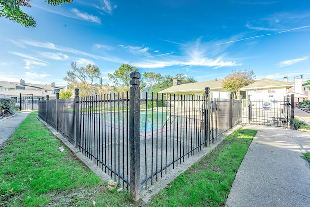 view of gate featuring a residential view and fence