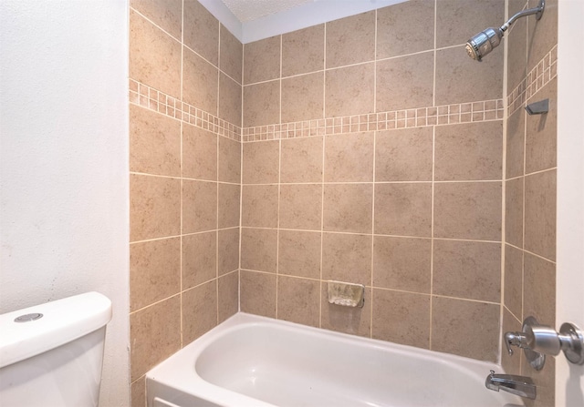 bathroom featuring toilet and bathing tub / shower combination