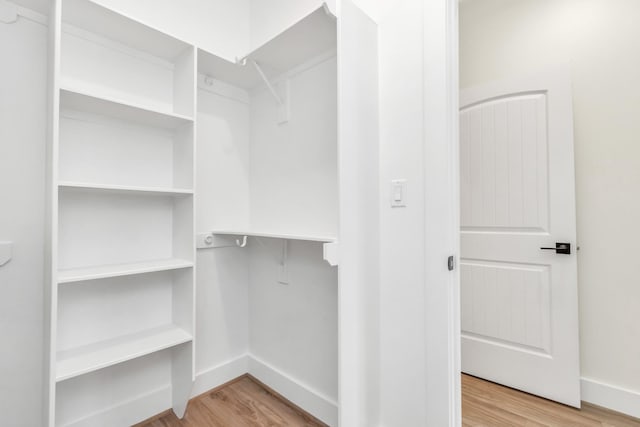 spacious closet with wood finished floors