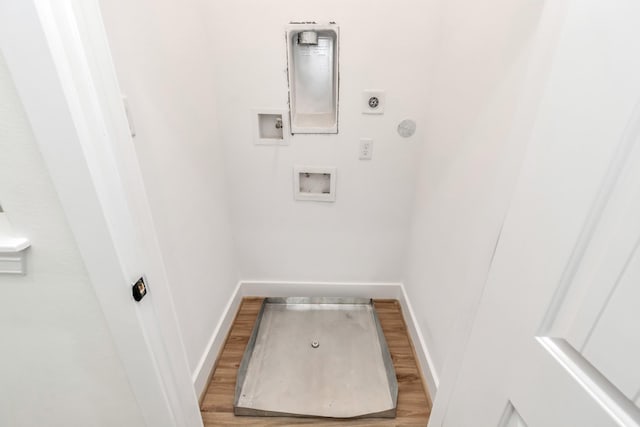 clothes washing area with hookup for an electric dryer, wood finished floors, baseboards, and washer hookup