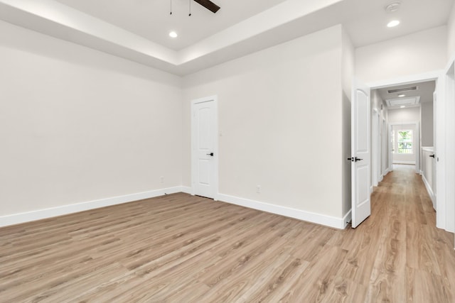 unfurnished room featuring visible vents, recessed lighting, light wood-type flooring, and baseboards