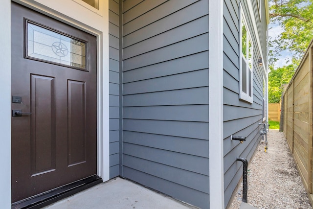 view of exterior entry with fence