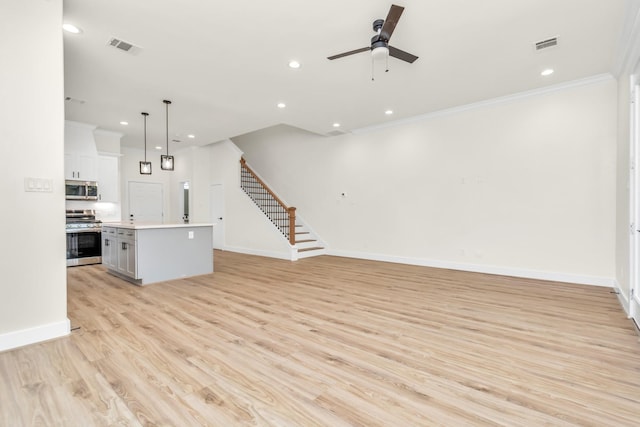 unfurnished living room with crown molding, stairway, light wood-style floors, and visible vents