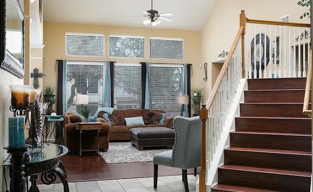 interior space with stairway, high vaulted ceiling, and a ceiling fan