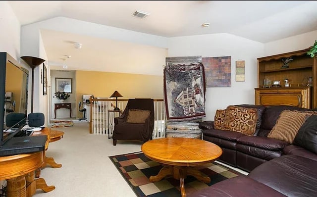 carpeted living room with vaulted ceiling and visible vents