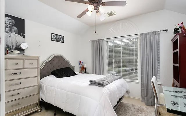 bedroom featuring visible vents, carpet flooring, lofted ceiling, and ceiling fan