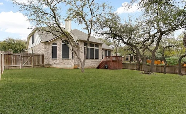 back of house with a yard, a chimney, stairs, and a fenced backyard