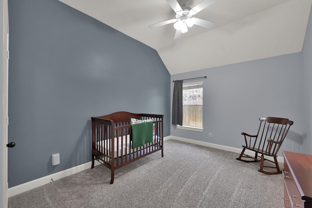 carpeted bedroom with lofted ceiling, a nursery area, baseboards, and ceiling fan