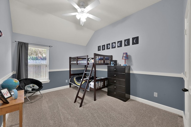 carpeted bedroom with ceiling fan, baseboards, and lofted ceiling