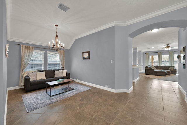 tiled living area featuring a wealth of natural light, visible vents, arched walkways, and crown molding