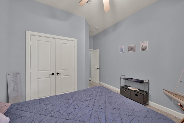 carpeted bedroom featuring a closet, baseboards, and ceiling fan