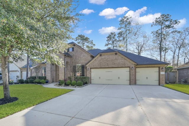 view of front of home featuring a front lawn, an attached garage, brick siding, and driveway