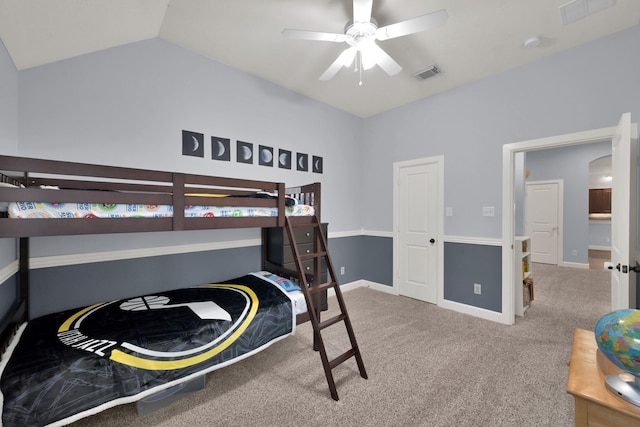 carpeted bedroom with visible vents, lofted ceiling, baseboards, and ceiling fan