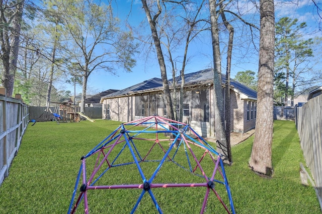 view of yard with a playground and a fenced backyard