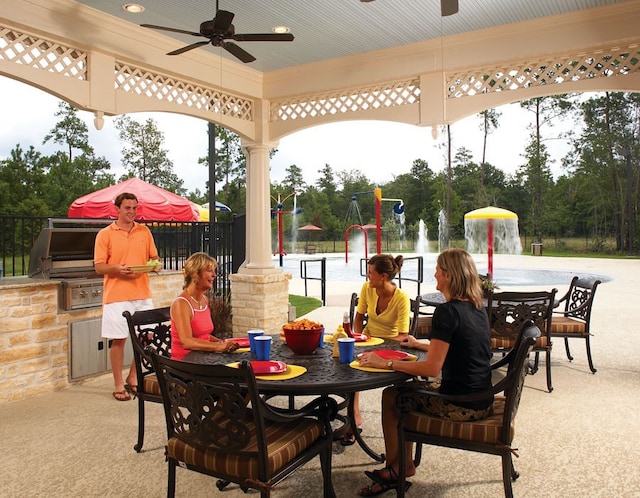 view of patio with outdoor dining area, a ceiling fan, and fence