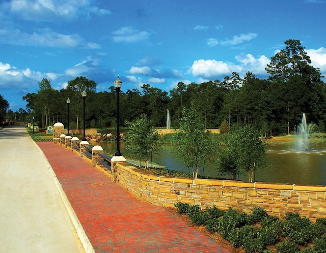 surrounding community featuring a water view