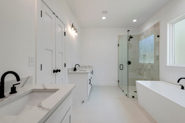 full bath featuring two vanities, visible vents, a stall shower, and a sink