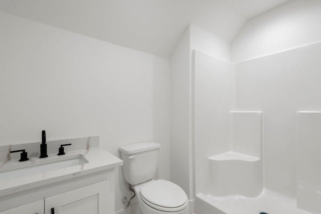 full bath featuring a shower, toilet, vanity, and vaulted ceiling