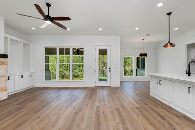 unfurnished living room featuring recessed lighting, light wood-type flooring, baseboards, and ceiling fan