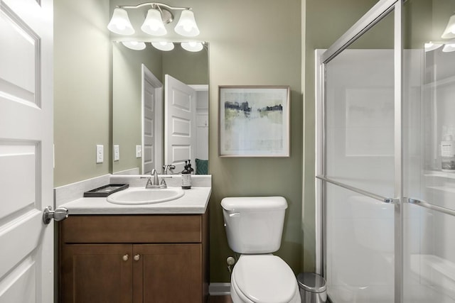 full bathroom with toilet, a stall shower, and vanity