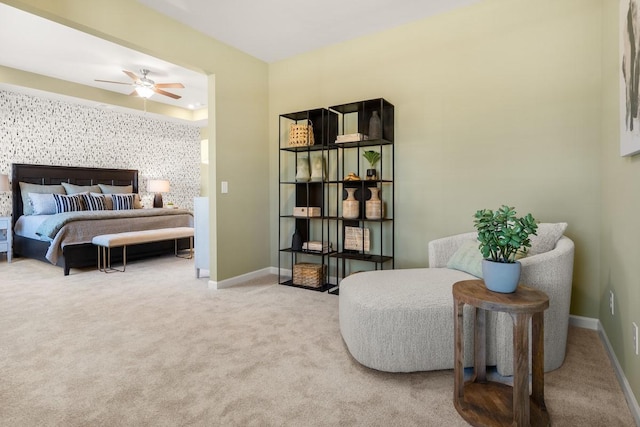 living area with baseboards, carpet floors, and ceiling fan