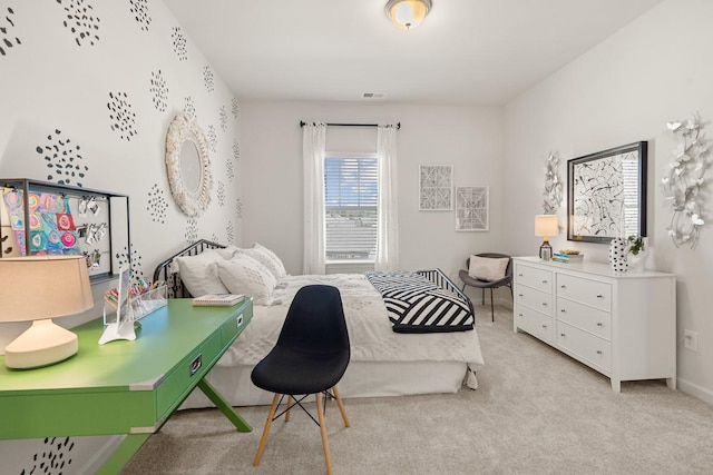 bedroom with visible vents, baseboards, and light colored carpet